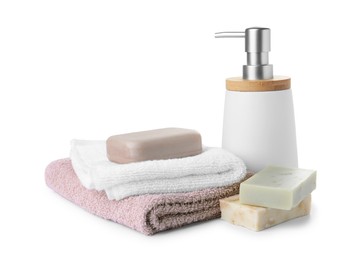 Photo of Soap bars, dispenser and terry towels on white background