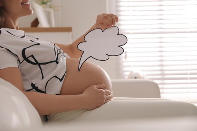 Pregnant woman with empty paper thought cloud indoors, closeup. Choosing baby name