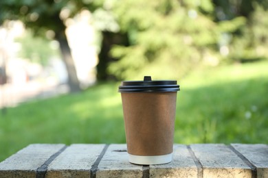 Photo of Paper cup on street outdoors. Takeaway drink