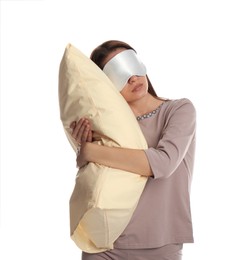 Young woman wearing pajamas and mask with pillow in sleepwalking state on white background