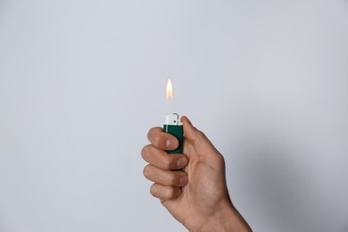 Woman holding lighter on white background, closeup
