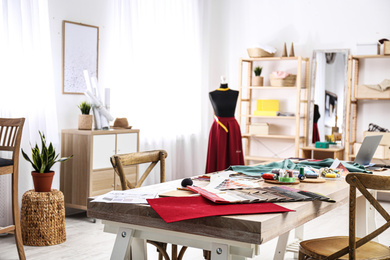 Fashion designer's workplace in studio. Creating new clothes