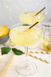 Delicious bee's knees cocktail on white table