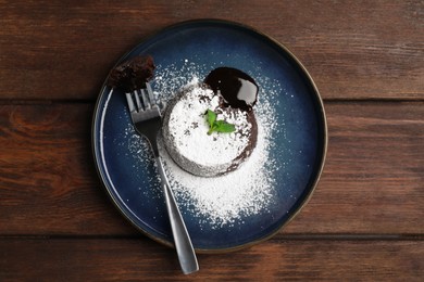 Delicious fresh fondant with hot chocolate and mint on wooden table, top view