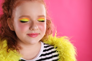 Cute indie girl with bright makeup on pink background, space for text