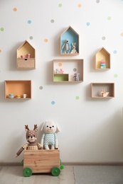 Stylish baby room interior design with house shaped shelves