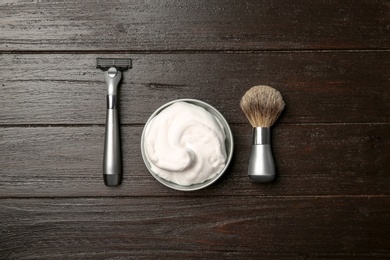 Flat lay composition with shaving accessories for men on wooden background