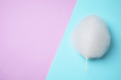 Sweet cotton candy on color background, top view. Space for text
