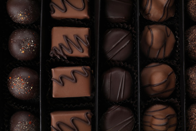 Many different chocolate candies in box, closeup