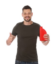 Man holding red container of motor oil and showing thumbs up on white background