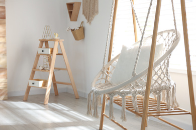 Comfortable hammock chair in stylish room. Home interior