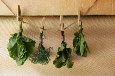 Bunches of different herbs on rope indoors