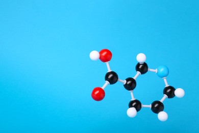 Photo of Molecule of vitamin B3 on light blue background, space for text. Chemical model