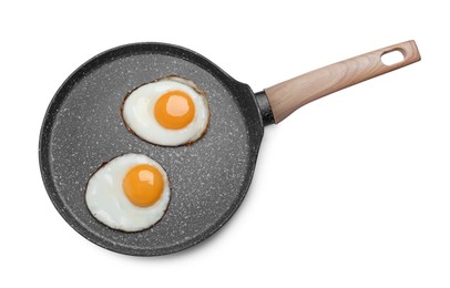 Frying pan with delicious fried eggs isolated on white, top view