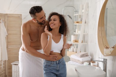 Photo of Lovely couple enjoying each other in bathroom at home