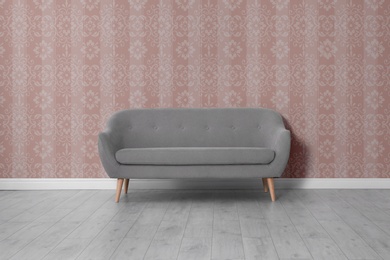 Modern sofa near patterned wallpapers. Interior design 