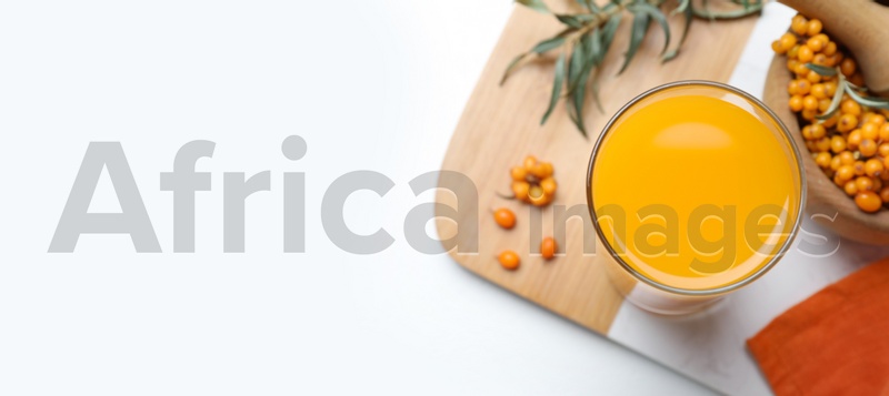 Top view of sea buckthorn juice on white table, space for text. Banner design
