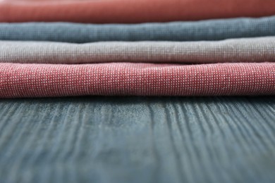 Different colorful napkins on wooden table, closeup. Space for text