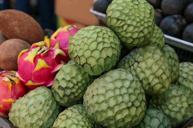 Cherimoya and dragon fruit at market, closeup
