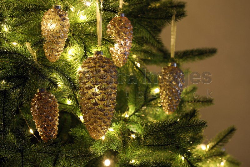 Christmas tree decorated with holiday baubles and fairy lights, closeup