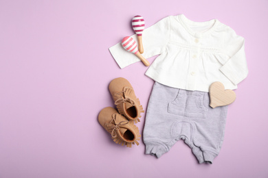 Flat lay composition with child's clothes on pink background, space for text