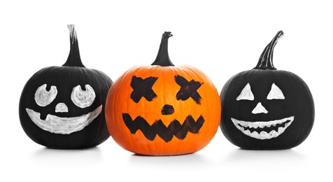 Halloween pumpkins with scary drawn faces on white background