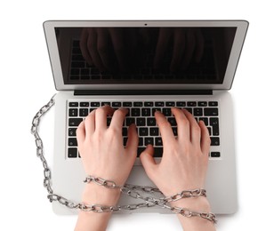 Woman with chained hands typing on laptop against white background, top view. Internet addiction