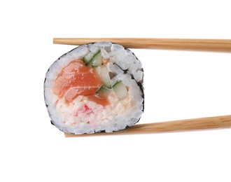 Chopsticks with tasty sushi roll on white background, closeup
