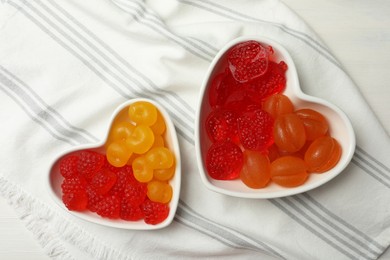 Delicious gummy fruit shaped candies on table, flat lay