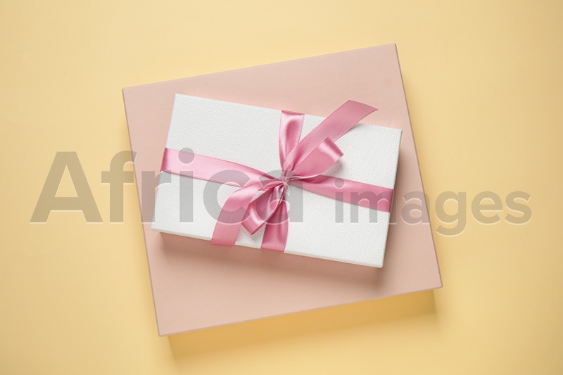 Beautiful gift boxes on beige background, top view