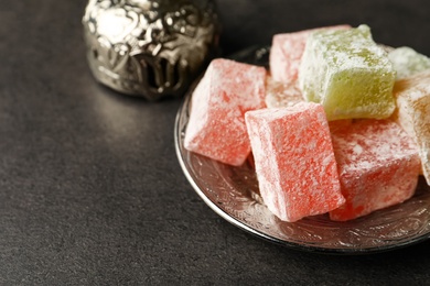 Turkish delight dessert on dark table, closeup. Space for text
