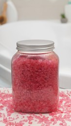 Jar with bath salt on table in bathroom