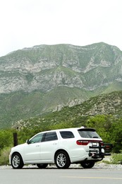 Photo of Beautiful view of mountains and car on roadside outdoors. Road trip