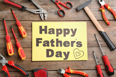 Flat lay composition with different tools and HAPPY FATHER'S DAY note on wooden background