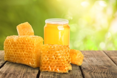 Image of Jar of honey on wooden table against blurred background