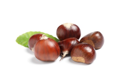 Photo of Fresh sweet edible chestnuts with green leaf on white background