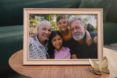 Framed family photo on wooden table in living room