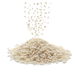 Sesame seeds falling into pile on white background 