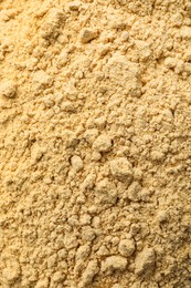 Photo of Aromatic mustard powder as background, top view