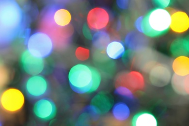Blurred view of glowing Christmas lights as background