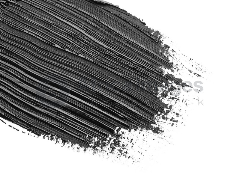 Brushstrokes of black oil paint on white background, closeup