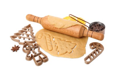 Photo of Christmas treat. Cookie cutters, dough and rolling pin on white background