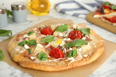 Delicious homemade pita pizza on white marble table