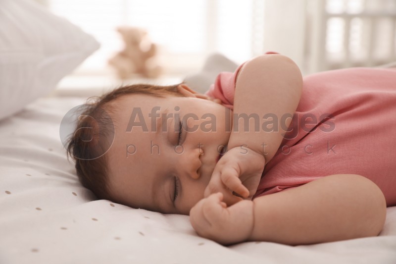 Photo of Cute little baby sleeping on bed at home, closeup