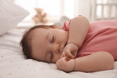 Photo of Cute little baby sleeping on bed at home, closeup