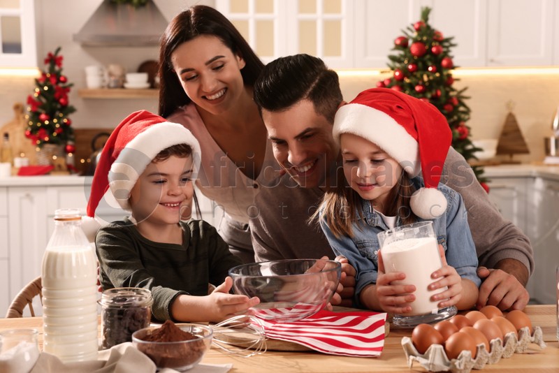 Happy family with ingredients for delicious Christmas cookies at home