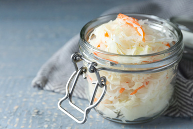 Tasty homemade fermented cabbage on wooden table, closeup