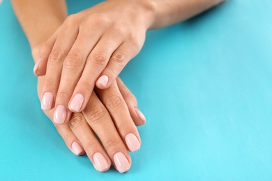 Closeup view of woman with beautiful hands on color background, space for text. Spa treatment