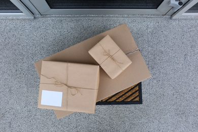 Delivered parcels on door mat near entrance, top view