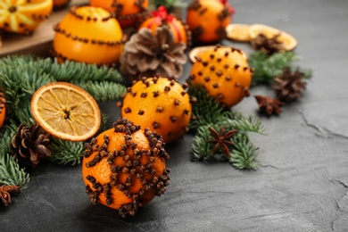 Pomander balls made of fresh tangerines with cloves  on dark table, space for text. Christmas atmosphere